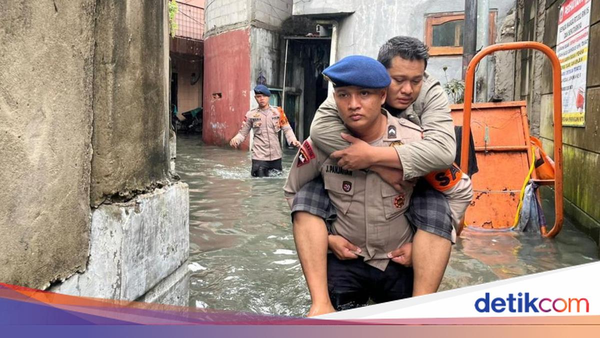 Brimob Polda Metro Gendong Warga Sakit yang Terjebak Banjir di Jakbar