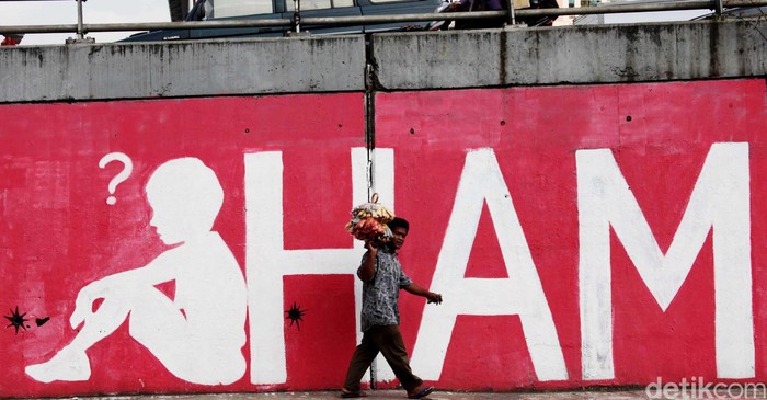 Pedagang melewati mural soal 14 tahun reformasi dan Hak Asasi Manusia (HAM) di Jl S.Parman, Grogol, Jakarta Barat, Kamis (24/5/2012). Mural
yang dibuat didepan kampus Trisakti tersebut menyindir kebijakan pemerintah yang seakan melupakan para martir reformasi 14 tahun lalu. File/DetikFoto.