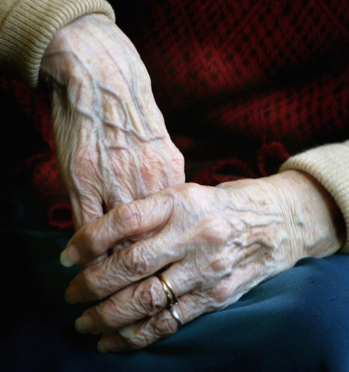 LONDON - APRIL 04:  A 90 year old Pensioners clasps her hands together during a group exercise in a day care centre on April 4, 2006 in London England. The State Pension Commission today defended its proposal of an age rise for when the pension can be taken, from 65 to 68 by the year 2050.  (Photo by Daniel Berehulak/Getty Images)