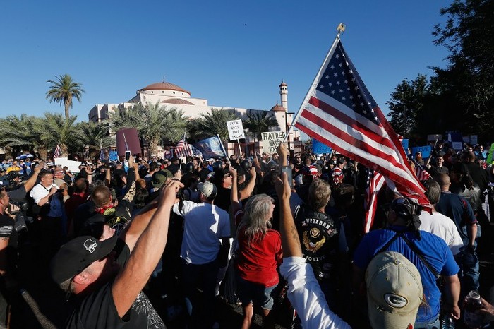PHOENIX, AZ - MAY 29: Protesters and counter-protesters rally outside the Islamic Community Center on May 29, 2015 in Phoenix, Arizona. Crowds gathered in response to a planned 