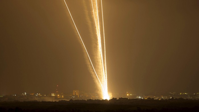 Light streaks and smoke trails are seen as rockets are launched from Gaza towards Israel in this July 23, 2014 file photo. Israel disputed on June 22, 2015 the findings of a U.N. report that it may have committed war crimes in the 2014 Gaza conflict, saying its forces acted 