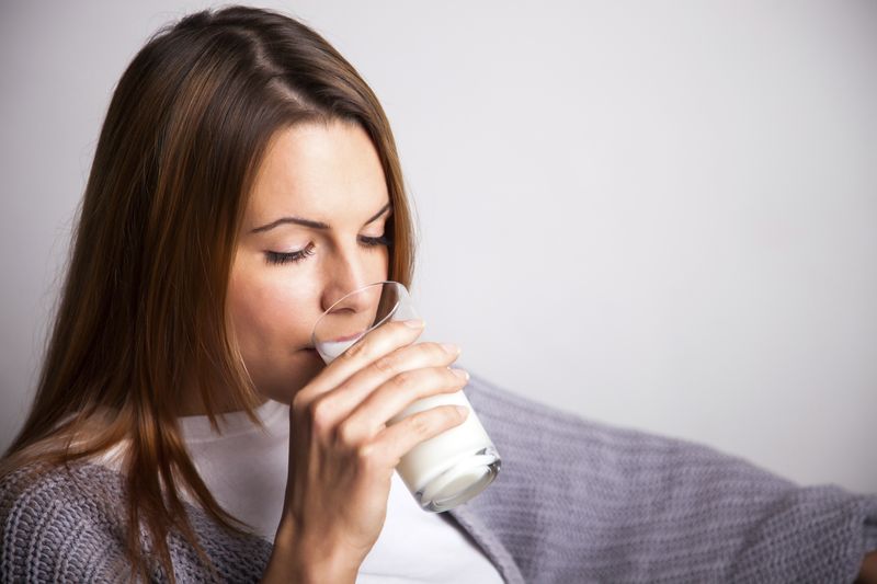 woman drinking a glass of milk