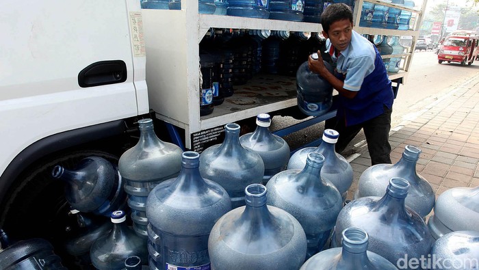 Permintaan air minum dalam kemasan mengalami lonjakan saat perayaan hari besar seperti pada saat Hari Raya Idul Fitri seperti saat ini. Lonjakan tersebut dinilai wajar karena memang kebutuhan masyarakat akan air minum dalam kemasan mengalami kenaikan dengan alasan praktis. Petugas tengah memindahkan galon-galon air dari truk di jalan RA Kartini, Kota Bekasi, Rabu (22/07/2015). Rengga Sancaya/detikcom.
