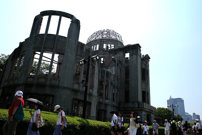 Hiroshima HIROSHIMA, JAPAN - AUGUST 05: People walk past the Atomic Bomb Dome at the Hiroshima Peace Memorial Park on one day before the 70th anniversary of the atomic bombing of Hiroshima on August 5, 2015 in Hiroshima, Japan. Japan marks the 70th anniversary of the first atomic bomb that was dropped by the United States on Hiroshima on August 6, 1945, killing an estimated number of 70,000 people instantly, with many tens of thousands more dying over the following years from the effects of radiation. Three days later another atomic bomb was dropped on Nagasaki, ending World War II. (Photo by Buddhika Weerasinghe/Getty Images)