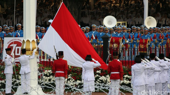 Presiden Joko Widodo menerima bendera pusaka dari anggota paskibraka Rani Noerinsan saat upacara penurunan bendera di Istana Merdeka, Jakarta, Senin (17/8/2015). Agung Pambudhy/Detikcom.