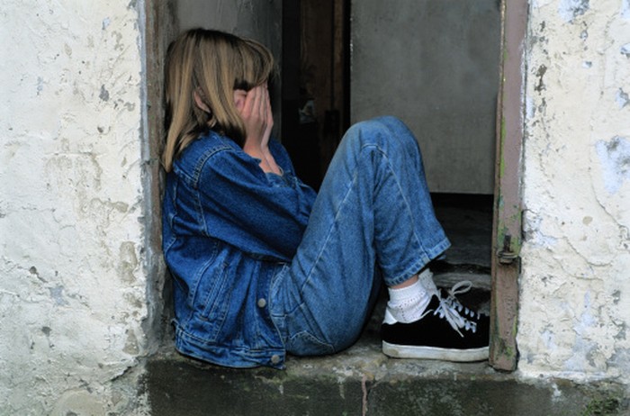 Girl (6-8) crying, side view