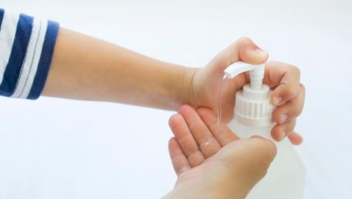 child disinfecting hands against the flu