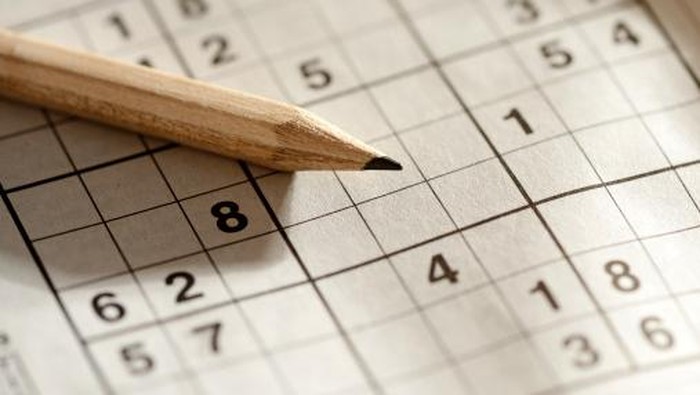 Pencil lying on a sudoku grid