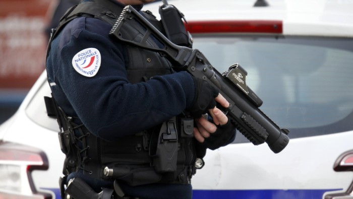 An armed French policeman stands in front of the nursery school where a hooded man claiming to be acting for Islamic State attacked a teacher with a knife in Aubervilliers, near Paris, France, December 14, 2015.  REUTERS/Charles Platiau