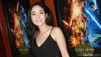 Ia tampil dibalut top hitam dan rok pensil abu-abu. Tas merah melengkapi gayanya. Pool/Gus Mun/detikFoto.