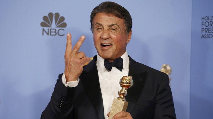 Sylvester Stallone poses backstage with the award for Best Performance by an Actor in a Supporting Role in any Motion Picture for his role in 