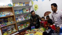 Noer Indradjaja dan Mahmud Hasibuan mendampingi beberapa anak belajar di Rumah Pintar.