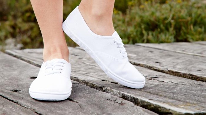 Full length of cheerful attractive woman in blue casual dress
