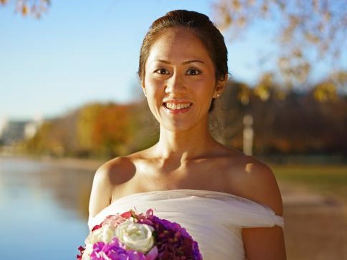 Asian beautiful bride holding her flowers