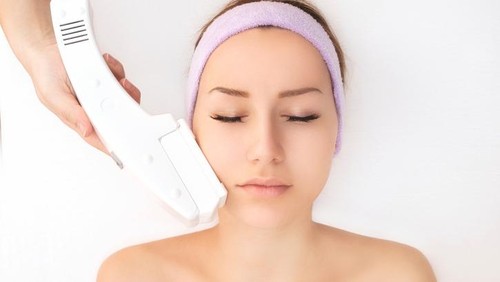 Young woman receiving laser therapy