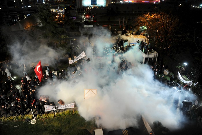 Riot police use tear gas to disperse protesting employees and supporters of Zaman newspaper at the courtyard of the newspapers office in Istanbul, Turkey, late March 4, 2016. Turkish authorities seized control of the countrys largest newspaper on Friday in a widening crackdown against supporters of U.S.-based Muslim cleric Fethullah Gulen, an influential foe of President Tayyip Erdogan. REUTERS/Selahattin Sevi /Zaman Daily EDITORIAL USE ONLY. NO RESALES. NO ARCHIVE