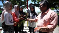 Gubernur Bangka Belitung Rustam Effendi membagikan kacamata gerhana kepada masyarakat  di kawasan Tanjung Pendam, Belitung, Senin (7/3/2016).