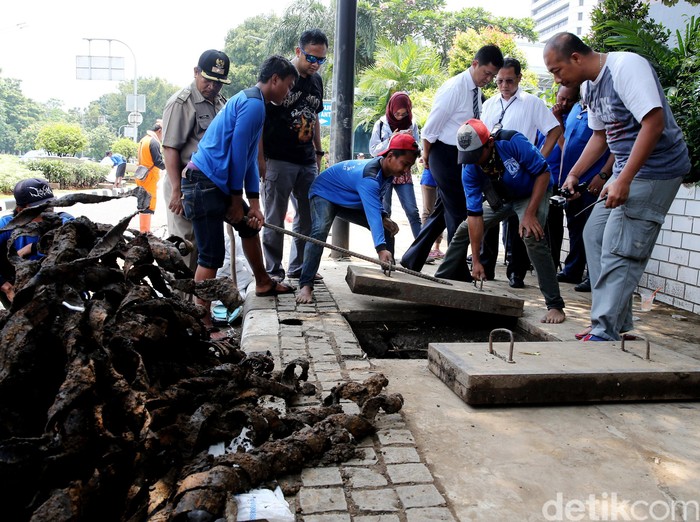 Lumpur yang Mulai Mengeras Jadi Kendala Petugas Angkut Sampah Bungkus Kabel