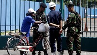 Salah seorang warga yang akan masuk ke SUGBK diperiksa oleh anggota TNI.