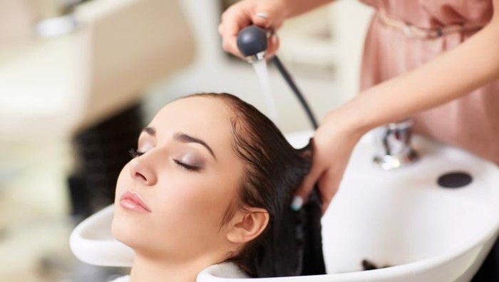 Woman having hair washed in hair salon, elevated view
