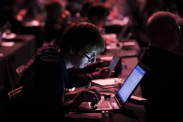 An attendee works at his laptop during the TechCrunch Disrupt 2015 conference in London, U.K., on Monday, Dec. 7, 2015. TechCrunch Disrupt gathers the best and brightest entrepreneurs, investors, and hackers to discuss whats top of mind for the tech industrys key innovators. Photographer: Jason Alden/Bloomberg via Getty Images