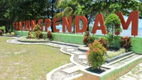 Foto: Tidak berapa lama setelah melewati gerbang, tampak tulisan besar Pantai Tanjung Pendam berwarna merah dengan pantai di belakangnya yang mempesona (Randy/detikTravel)