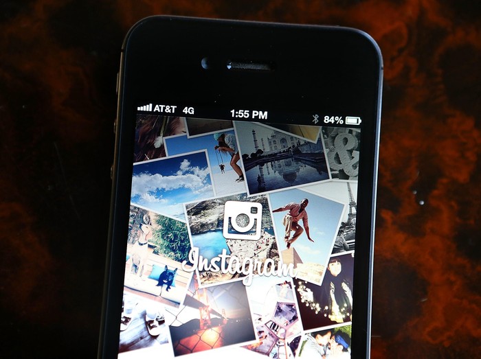 MENLO PARK, CA - JUNE 20:  An attendee takes a photo of the instagram logo during a press event at Facebook headquarters on June 20, 2013 in Menlo Park, California. Facebook announced that its photo-sharing subsidiary Instagram will now allow users to take and share video.  (Photo by Justin Sullivan/Getty Images)