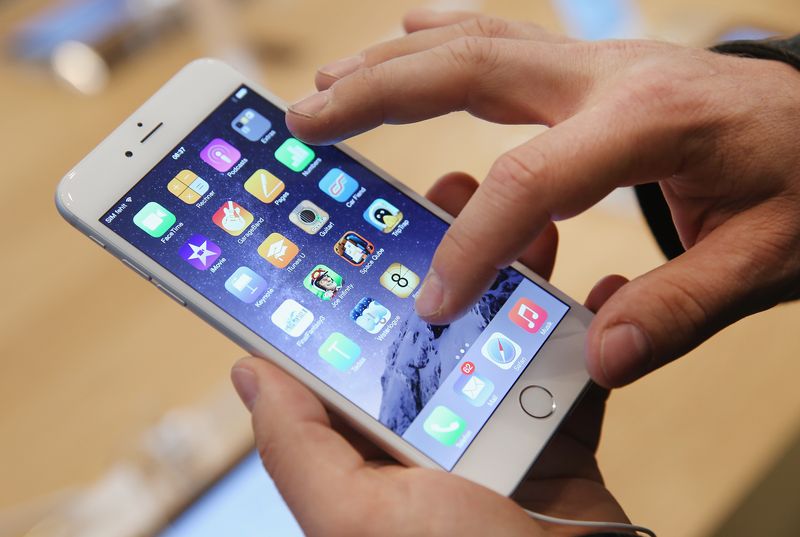 BERLIN, GERMANY - SEPTEMBER 19:  A shopper ltries out the new Apple iPhone 6 at the Apple Store on the first day of sales of the new phone in Germany on September 19, 2014 in Berlin, Germany. Hundreds of people had waited in a line that went around the block through the night in order to be among the first people to buy the new smartphone, which comes in two versions: the Apple iPhone 6 and the somewhat larger Apple iPhone 6 Plus.  (Photo by Sean Gallup/Getty Images)