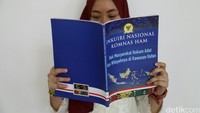 Pengunjung membaca buku tentang Inkuiri Nasional.