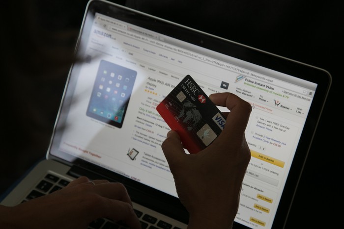 BRISTOL, UNITED KINGDOM - AUGUST 11:  In this photo illustration a woman uses a credit card to buy something online on August 11, 2014 in Bristol, United Kingdom. This week marks the 20th anniversary of the first online sale. Since that sale - a copy of an album by the artist Sting - online retailing has grown to such an extent that it is now claimed that 95 percent of the UK population has shopped online and close to one in four deciding to shop online each week.  (Photo Illustration by Matt Cardy/Getty Images)