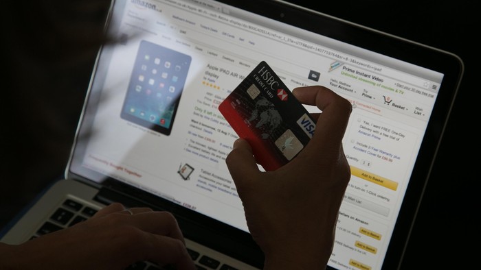 BRISTOL, UNITED KINGDOM - AUGUST 11:  In this photo illustration a woman uses a credit card to buy something online on August 11, 2014 in Bristol, United Kingdom. This week marks the 20th anniversary of the first online sale. Since that sale - a copy of an album by the artist Sting - online retailing has grown to such an extent that it is now claimed that 95 percent of the UK population has shopped online and close to one in four deciding to shop online each week.  (Photo Illustration by Matt Cardy/Getty Images)