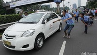 Beberapa orang sopir melakukan perusakan taksi yang kebetulan lewat.