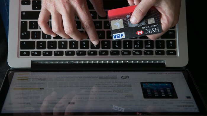 BRISTOL, UNITED KINGDOM - AUGUST 11:  In this photo illustration a woman uses a credit card to buy something online on August 11, 2014 in Bristol, United Kingdom. This week marks the 20th anniversary of the first online sale. Since that sale - a copy of an album by the artist Sting - online retailing has grown to such an extent that it is now claimed that 95 percent of the UK population has shopped online and close to one in four deciding to shop online each week.  (Photo Illustration by Matt Cardy/Getty Images)