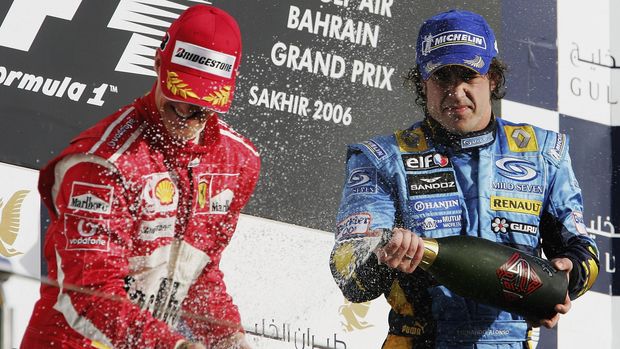 SAKHIR, BAHRAIN - MARCH 12:  Fernando Alonso of Spain and Renault sprays Michael Schumacher with champagne after winning the Bahrain Formula One Grand Prix at the Bahrain International Circuit on March 12, 2006 in Sakhir, Bahrain  (Photo by Clive Mason/Getty Images)
