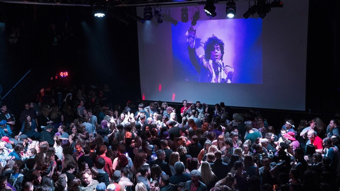 MINNEAPOLIS, MN - APRIL 21:  People listen to Prince music during a memorial street party outside the First Avenue nightclub on April 21, 2016 in Minneapolis, Minnesota. Prince, 57, was pronounced dead shortly after being found unresponsive today at Paisley Park Studios in Chanhassen, Minnesota near Minneapolis.  (Photo by Scott Olson/Getty Images)