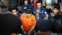 Tangan Hartawan tampak diborgol. Tak ada komentar yang diucapkannya. Dia tertunduk saat digiring ke mobil Pajero Sport hitam yang membawanya ke Kejagung.