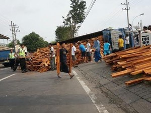Truk Muat Ribuan Balok Kayu Terguling Tutup Jalur Jombang-Lamongan