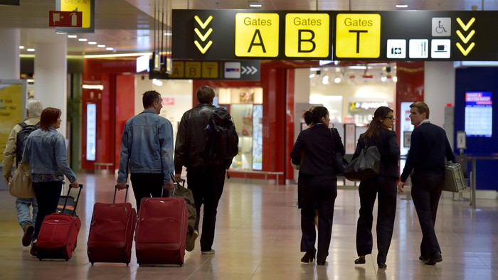 Members of staff and travellers walk in the departure hall after a ceremony at Brussels Airport as it reopens 40 days after deadly attacks in Zaventem, Belgium, May 1, 2016. REUTERS/Eric Vidal