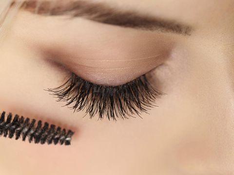 Woman eye with beautiful makeup and long eyelashes. Mascara Brus