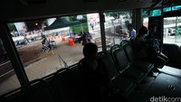 Penumpang menaiki bus TransJakarta.