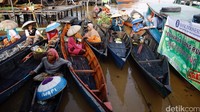 Para pedagang mengantre dari atas perahunya.