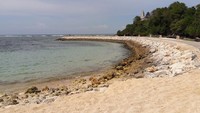 Foto: Garis pantainya cukup panjang untuk dijelajahi. Jika berjalan terus hingga ujung, ada Pura Geger Dalem Pemutih yang tampak berdiri di atas tebing (Kurnia/detikTravel)