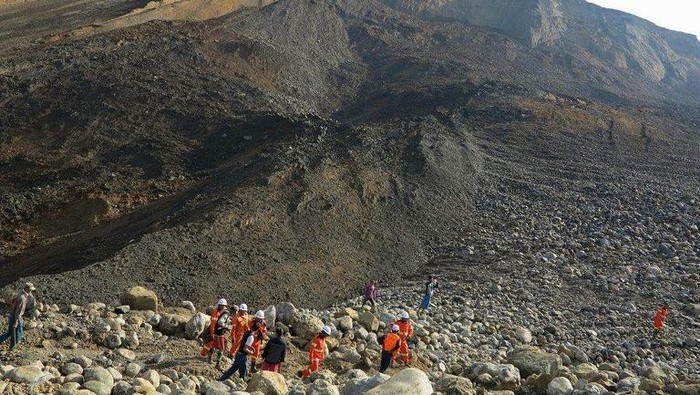 Rescue workers are pictured at the site of a landslide on December 26, 2015 in Hpakant, Kachin State, the war-torn area that is the epicentre of Myanmars secretive billion dollar jade industry. Rescuers were searching through mud and rubble after a new landslide buried workers in the remote jade mining region in northern Myanmar, the second such incident in just over a month. AFP PHOTO / AFP PHOTO / STR