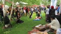 man Gimbot (baju putih) bermain kecapi di stand Disbudpar Jabar. Banyak warga London tertarik dengan alat musik tradisional sunda ini (Fitraya/detikTravel)