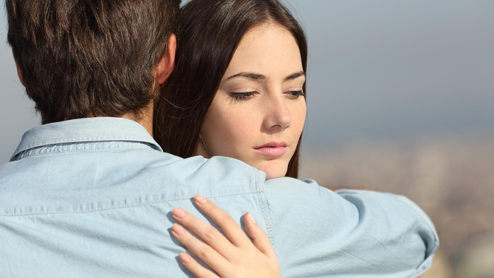 475327624 Sad woman hugging her boyfriend and looking down couple problems concept