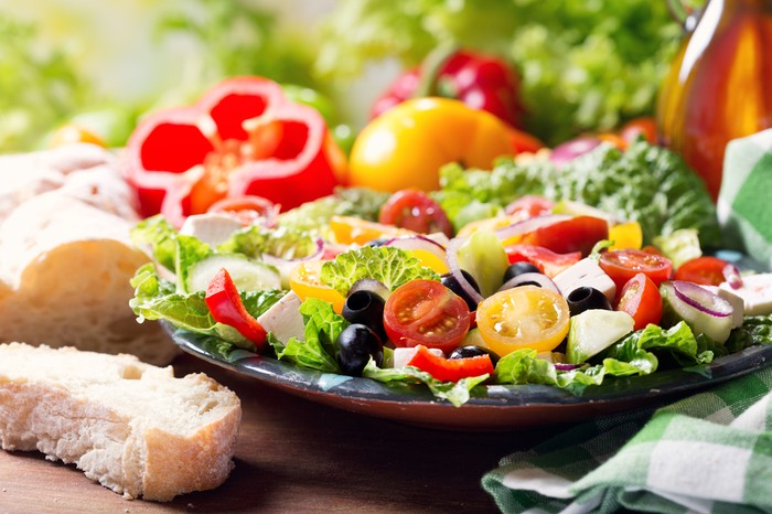 Delicious colorful fruit salad close up. Fruits in background. Light summer food. The greatest wealth is health.  ~Virgil