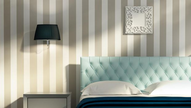 3d render of a contemporary elegant luxury bedroom with blue stools and a striped wallpaper
