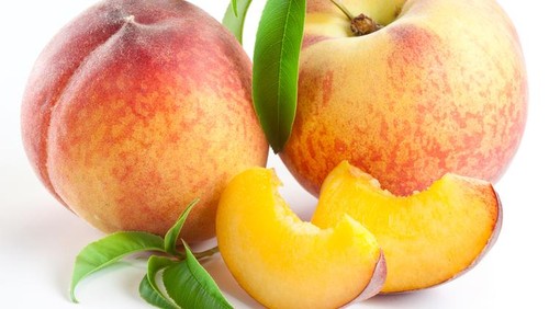 Ripe peach fruit with leaves and slises on white background.