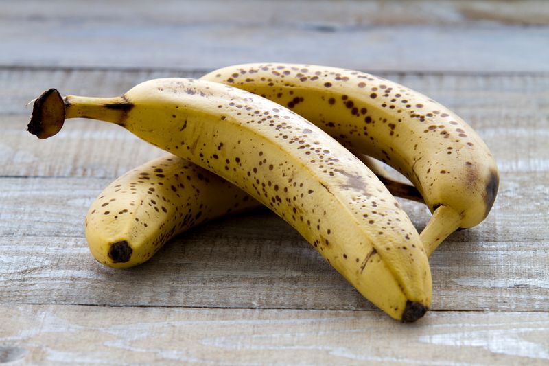 Ripe bananas on rustic background