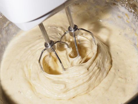 Electric mixer beaters beating eggs
